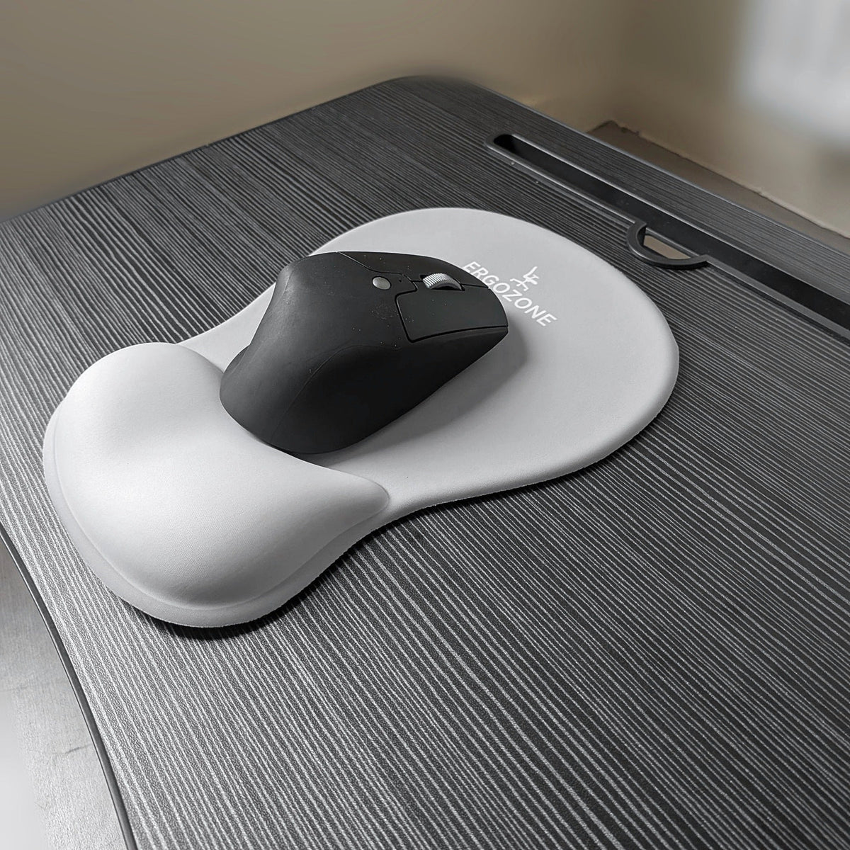 Kit ergonomique Ergozone gris : souris verticale sans fil posée sur le tapis de souris gris avec repose-poignet